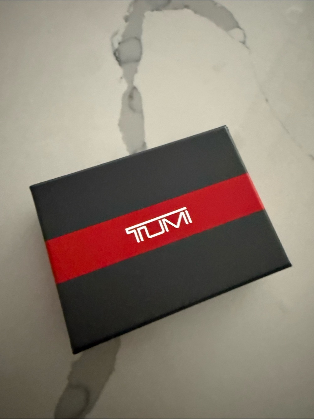 Tumi Gun Metal Wallet with Silver Logo and Zipper